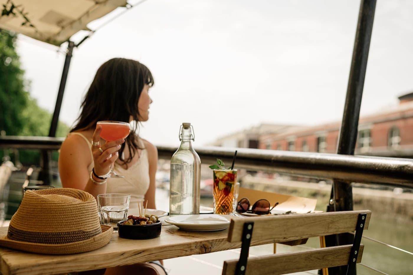 A cocktail and olives looking out over the harbour