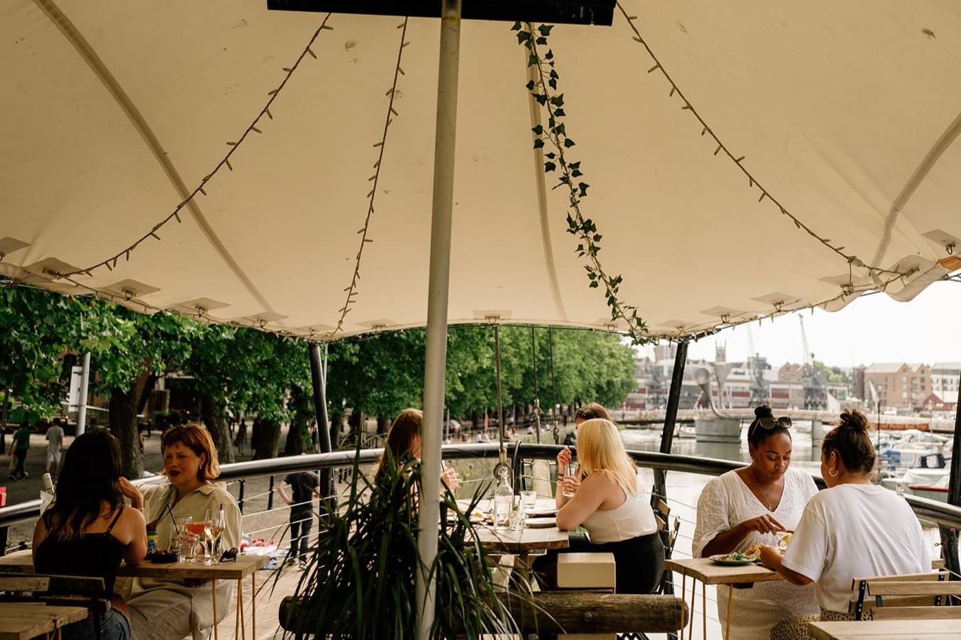 Guests dining under the canopy on the top deck